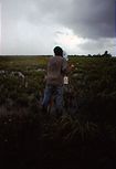 Mark Lamble filming rainstorm on the floodplains