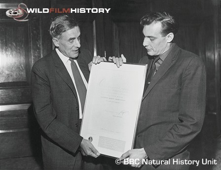 Desmond Hawkins presenting Ronald Eastman with replica of the diploma and silver medal awarded to his film The Private Life of the Kingfisher