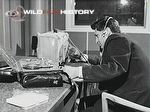 John F. Burton recording the sound of a grasshopper using a Nagra IIIb Tape Recorder and an illuminated cage