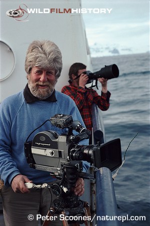 Hugh Miles with camera while filming from a boat for Life in the Freezer