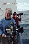 Hugh Miles with camera while filming from a boat for Life in the Freezer