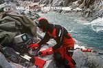 Monitoring a remote underwater camera (in water behind diver) for Life in the Freezer