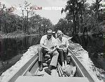 Armand and Michaela Denis travelling by boat during filming for On Safari