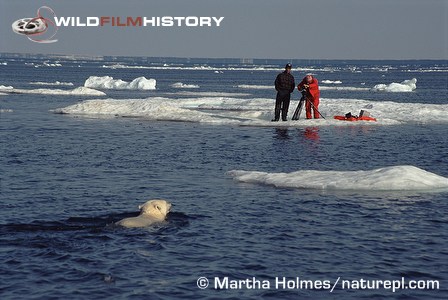 Doug Allan with Inuit guide on ice floe filming a swimming polar bear for The Wildlife Specials: Polar Bear