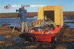 Des Bartlett filming beside an Argo all terrain vehicle