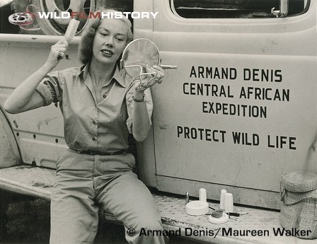 Michaela Denis brushing her hair beside Armand Denis' Central African Expedition vehicle