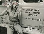 Michaela Denis brushing her hair beside Armand Denis' Central African Expedition vehicle