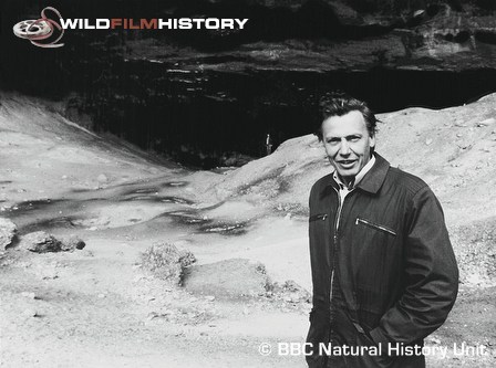 David Attenborough outside a cave entrance during filming for Life on Earth